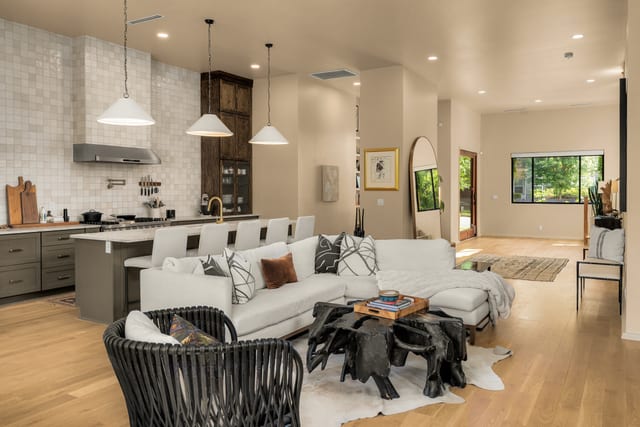 Open living room with a large sectional beside the chef's kitchen.