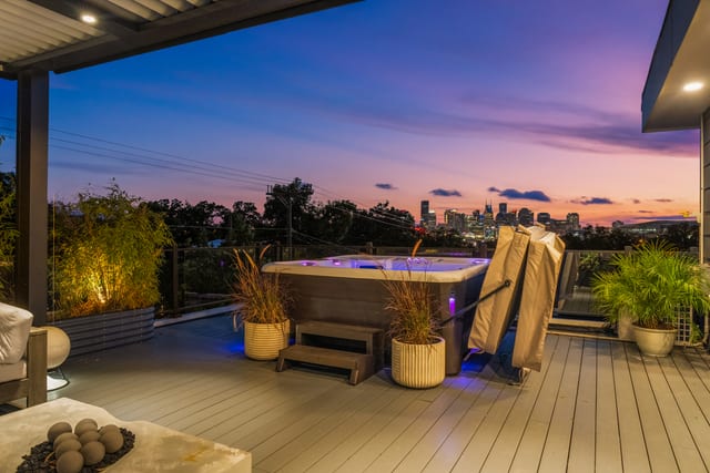 Rooftop spa and terrace overlooking the downtown Nashville skyline at twilight.